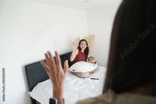 Wallpaper Mural Young women playing video games together in living room. Torontodigital.ca