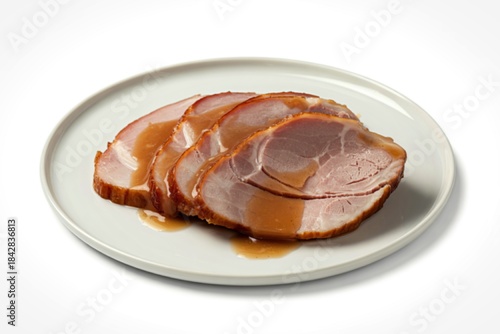 thinly sliced ham arranged on a white ceramic plate
