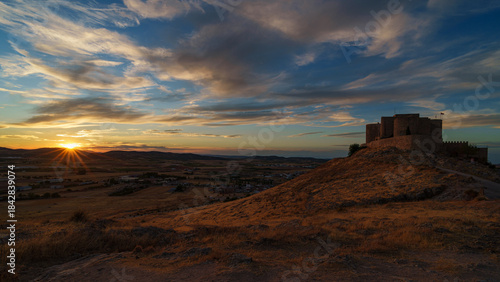 Panoramic view of Consuegra Castle at sunset, Toledo, Spain.