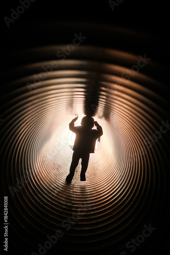Child playing in corrugated plastic park tunnel