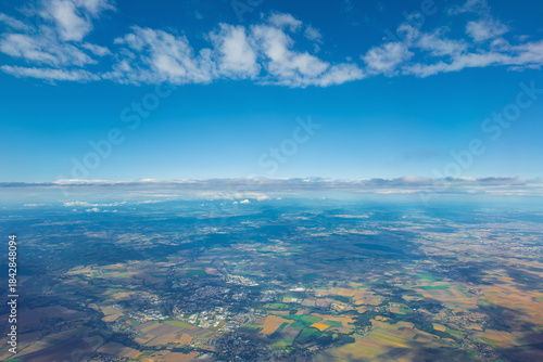 Photography Aerial view of countryside under bright blue sky with clouds