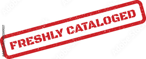 Distressed rectangular rubber stamp showing the text FRESHLY CATALOGED on a clean surface for inventory management