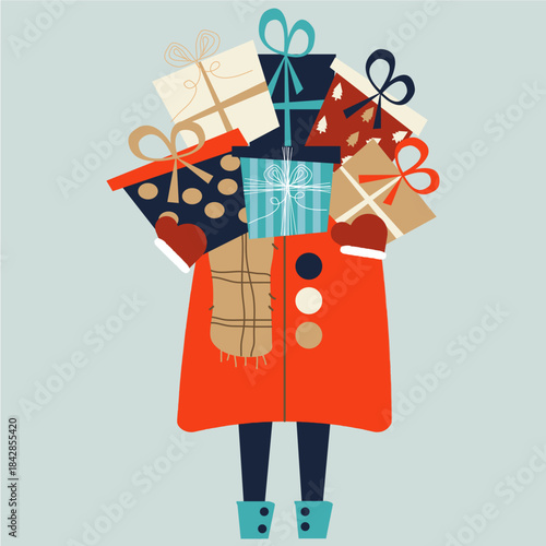 Person holding a large stack of colorful wrapped christmas presents