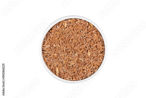 A bowl of brown grains with a white background