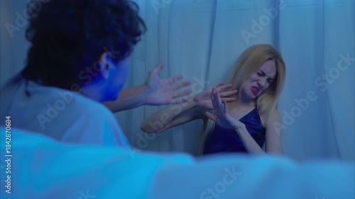 A couple talking and relaxes in their bedroom before bed on a night with a blue moon