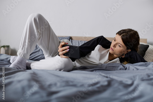 Young woman embraces a day of relaxation while bed rotting in her cozy apartment space