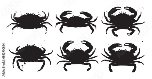 Six black crab silhouettes with a grunge ink splatter effect, creating a rustic and artistic marine life illustration perfect for various designs.