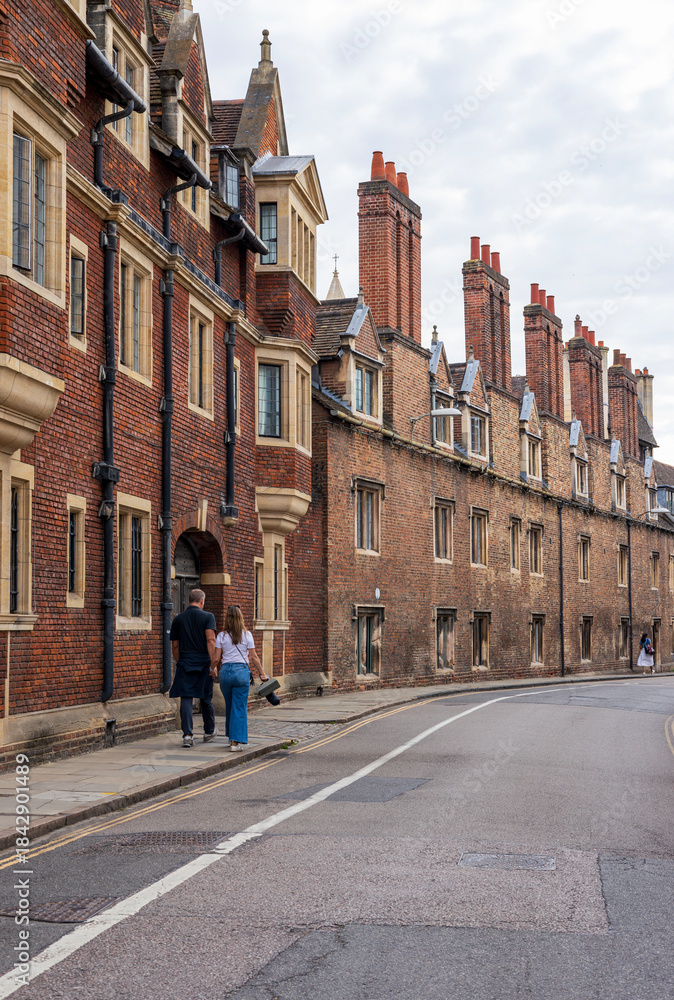 Fototapeta premium An empty alley in Cambridge old town with traditional terraced houses and Cambridge cathedral. 