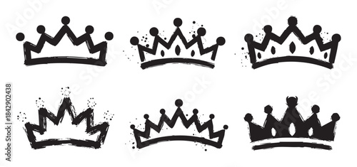 Six black hand drawn crown illustrations with a grunge, brushstroke style, perfect for adding a touch of royalty, success, or achievement to any design project.