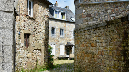 Residential Courtyard with Stone Cottage Walls in Domfront, France