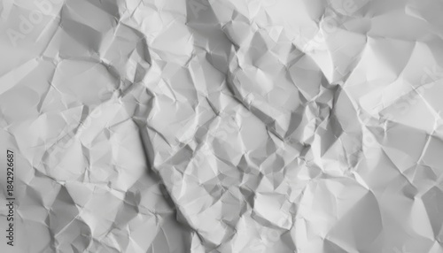 Abstract background texture of highly crumpled white paper with deep wrinkles, creases