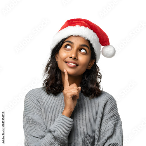 Young Indian woman wearing Santa Claus hat thinking and looking upward with thoughtful expression isolated on transparent background