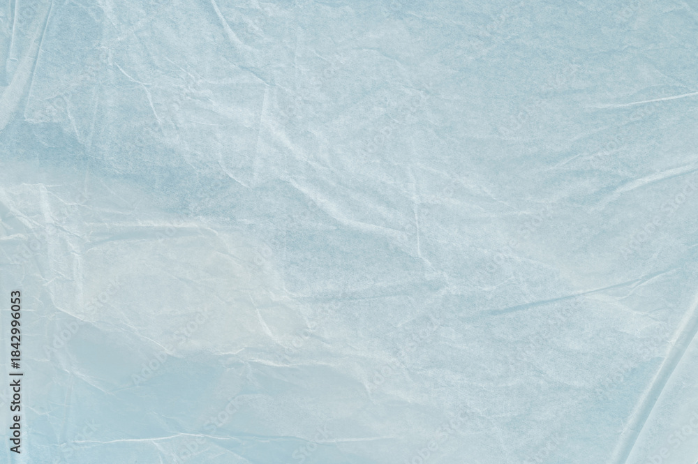 Obraz premium Light shines through crumpled plastic wrap on a table