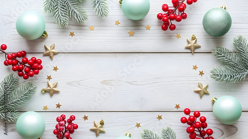 Rustic holiday border with Christmas decorations, pinecones, and stars on wooden background