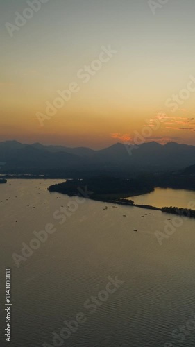 sunset hangzhou city famous lake boat ferry traffic aerial vertical timelapse panorama 4k china