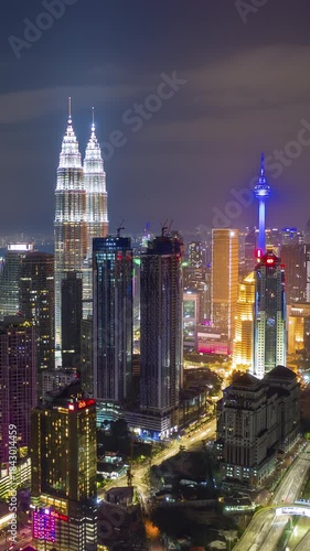night illumination kuala lumpur cityscape downtown traffic road interchange aerial vertical panorama 4k timelapse malaysia