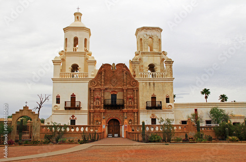San Xavier Del Bac Mission on the Tohono Oodham reservation in the village of Wark, near Tucson, Arizona, USA with light colored sky copy space, is an example of Spanish Colonial Architecture.