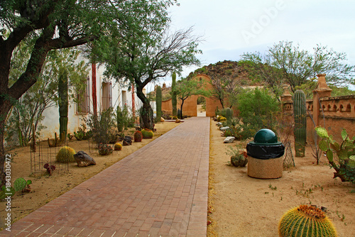 Garden and sidewalk outside San Xavier Del Bac Mission on the Tohono Oodham reservation in the village of Wark, near Tucson, Arizona, USA.