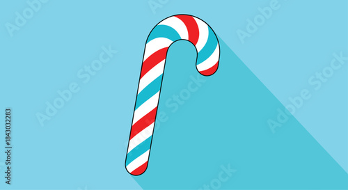 Candy cane with red white and blue swirls stands on a bright blue background casting a long diagonal shadow and evoking a playful festive mood.
