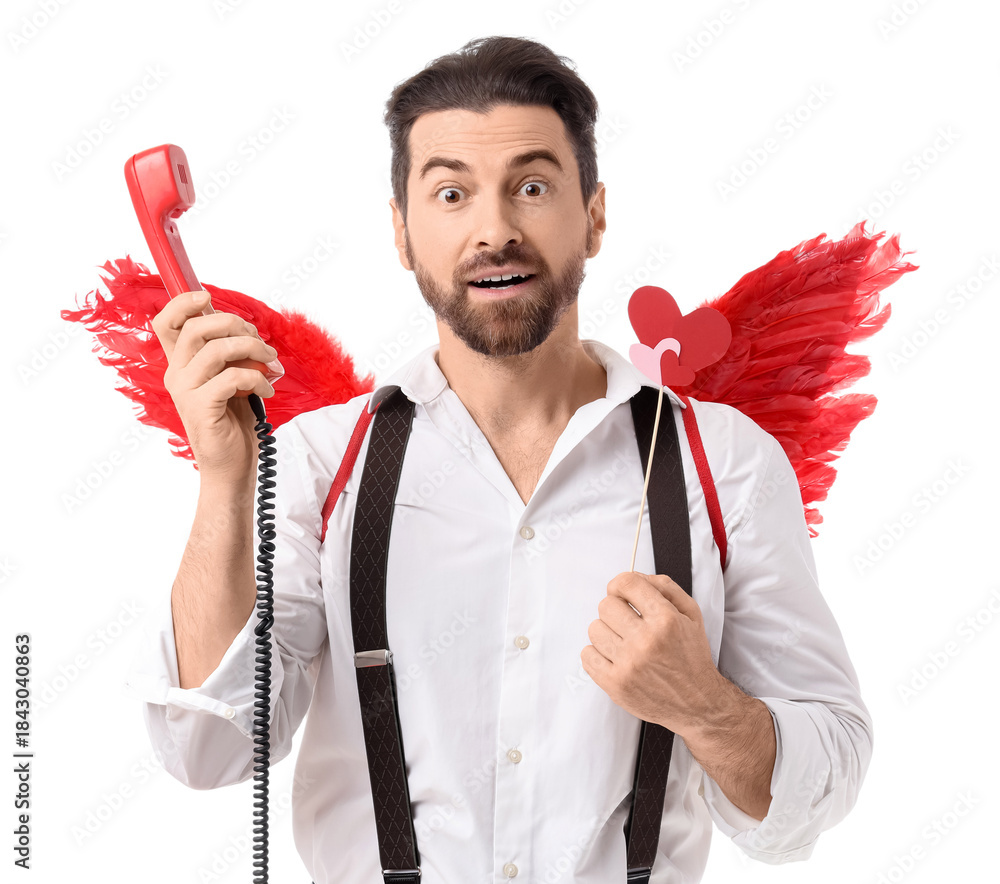 Obraz premium Surprised man dressed as Cupid with telephone on white background. Valentine's Day celebration