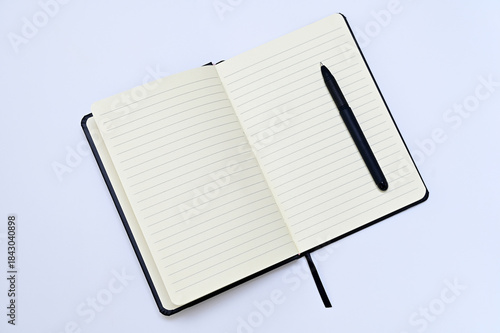 blank pages of notepad and pen on white background