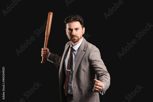 Angry businessman with bat ...