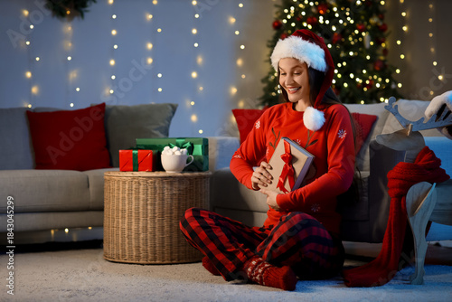 Young girl in Santa hat and...