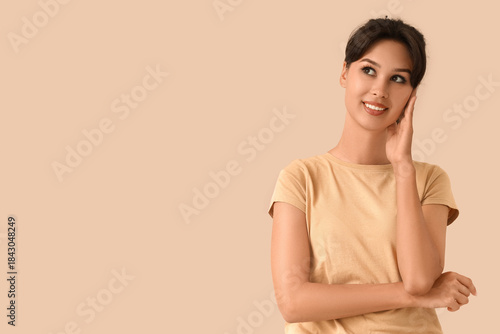 Dreaming young woman on bei...