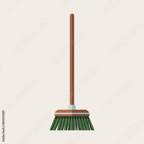 A broom with a brown handle and green bristles stands upright.