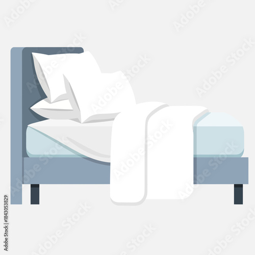 Bed with pillows and blanket in shades of white and blue.