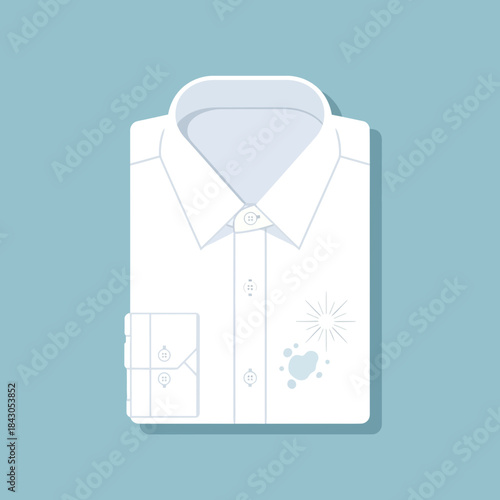 Folded white shirt with buttons and a stain on the front.