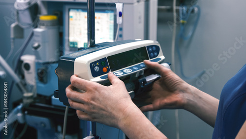 Konstfotografi Medical professional adjusting a modern infusion pump in a clinical setting, sho