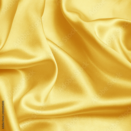 Shiny yellow satin fabric background, smooth silk folds, luxury textile, elegant drapery, glamorous cloth texture for fashion, wedding, banner design.