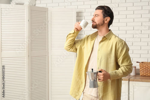 Young man drinking fresh co...