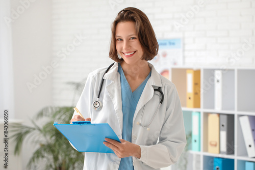 Happy female doctor with cl...