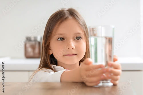 Cute little girl with glass...
