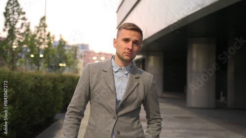 Wallpaper Mural Young man walking and taking off sunglasses in the city. Slow motion Torontodigital.ca