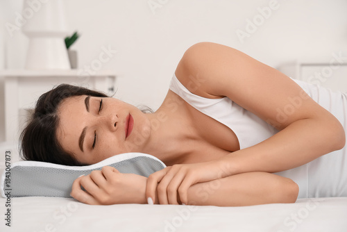 Young woman in pajamas with...