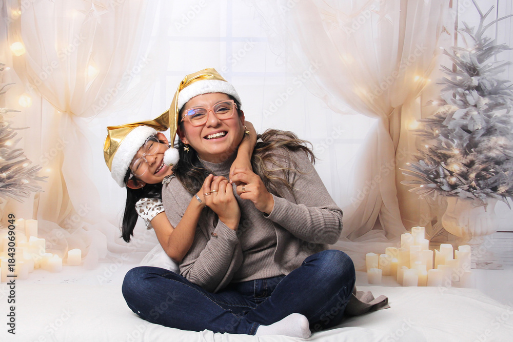 Naklejka premium Divorced single mother and her 5-year-old Latina daughter with glasses excited celebrate Christmas and New Year's together, wearing Santa hats