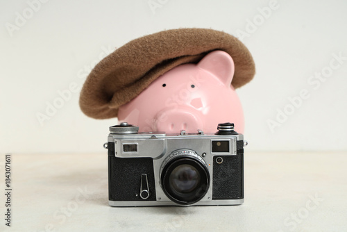 Piggy bank in beret with ca...