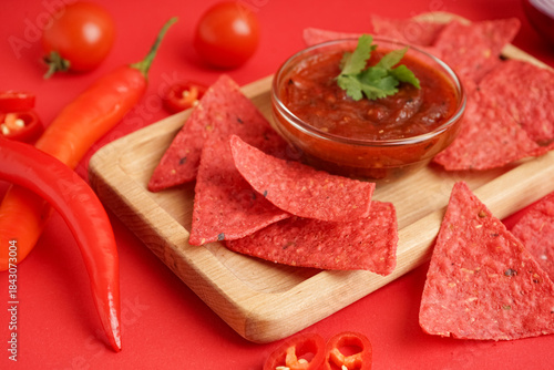 Wooden tray with red nachos...
