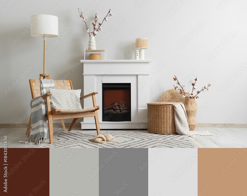 Obraz premium Fireplace, armchair, wicker basket and vases with cotton flowers in interior of living room. Different color patterns
