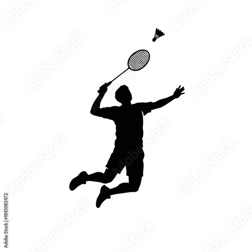 Silhouette of a male badminton player jumping high to smash a shuttlecock with a racket during a game.