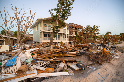 Wallpaper Mural Piles of debris on street side in Florida. Hurricane aftermath cleanup. Garbage from severely damaged homes after storm surge. Consequences of natural disaster Torontodigital.ca