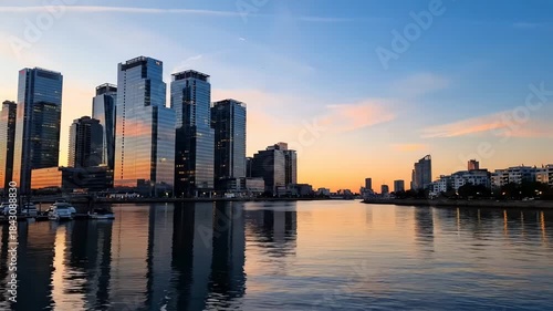 Wallpaper Mural Serene cityscape at dusk with towering skyscrapers and their beautiful reflections in the calm water Torontodigital.ca