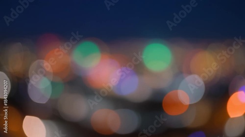 Vibrant and colorful bokeh lights creating an abstract and dreamy background at night.