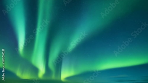 Vibrant green and blue Aurora Borealis lights shimmer and reflect symmetrically over a calm surface, showcasing the ethereal beauty of the natural phenomenon in a starry night sky.