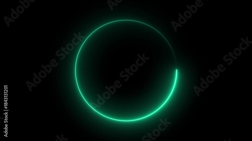 Glowing green circle rotating slowly on black background with neon light effects