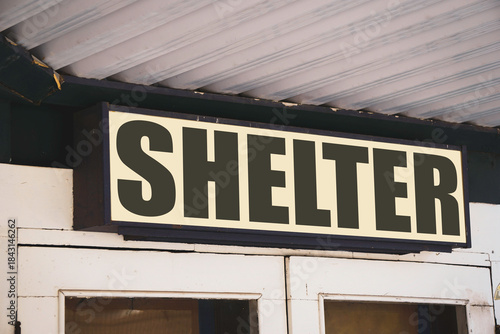 Aged shelter sign on building