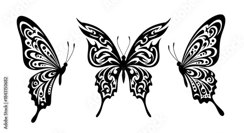 Three black and white tribal style butterflies with intricate patterns, depicted in different orientations.